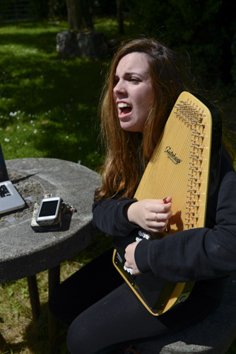 Nesli is working out a musical composition on her auto-harp.